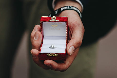 person holding box of silver-colored ring with clear gemstone, closeup photography of person holding clear gemstones silver-colored princess-cut ring in box HD wallpaper