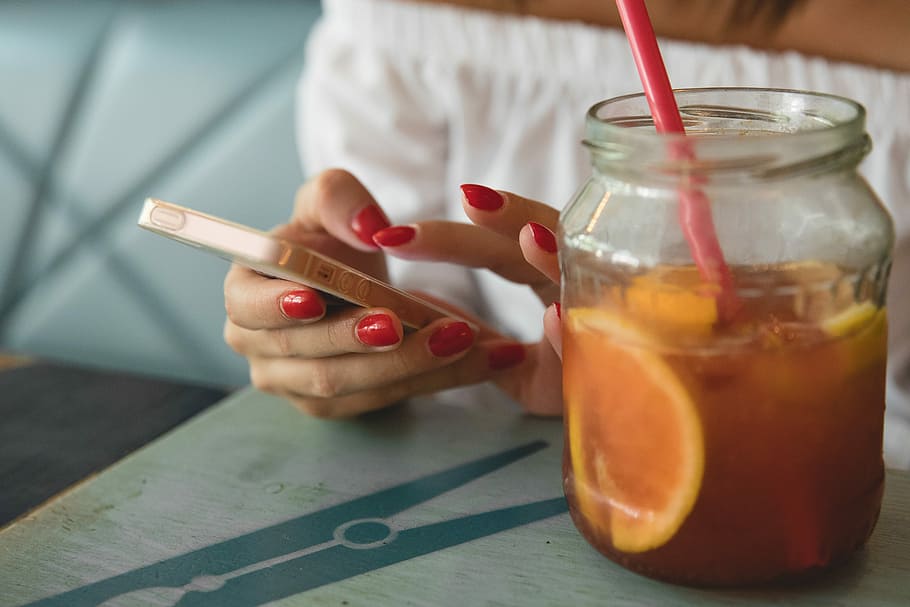 person holding rose gold SE beside jar on top of table, refreshment HD wallpaper