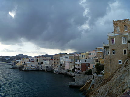Heavy Clouds near the cliffs and coastline in Ermoupoli, Greece HD wallpaper