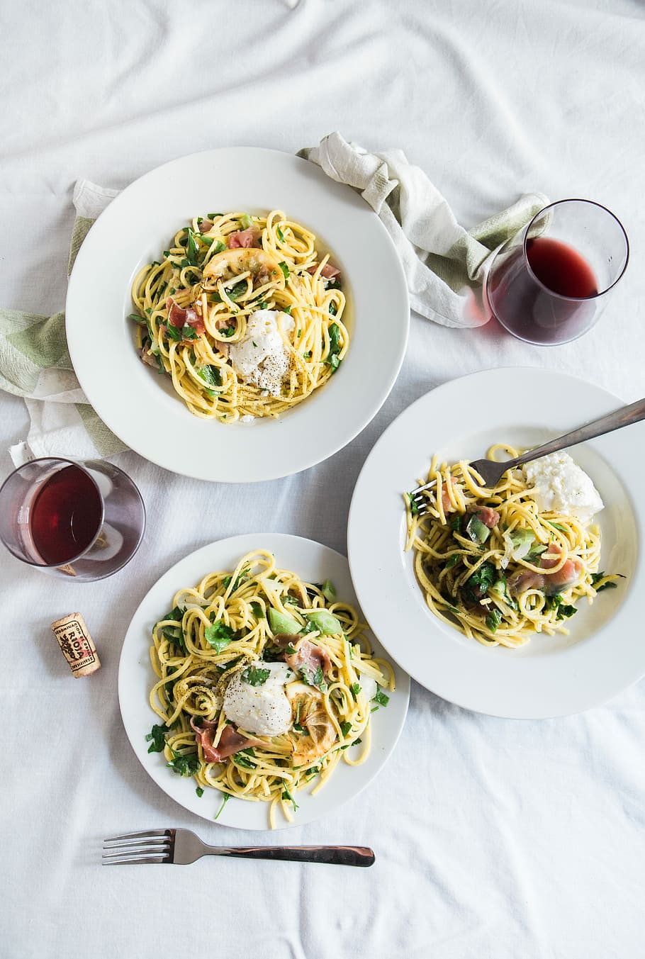three round white plates with pasta near two glass cuups, three plates of seafood carbonaras with two glasses of wines HD wallpaper