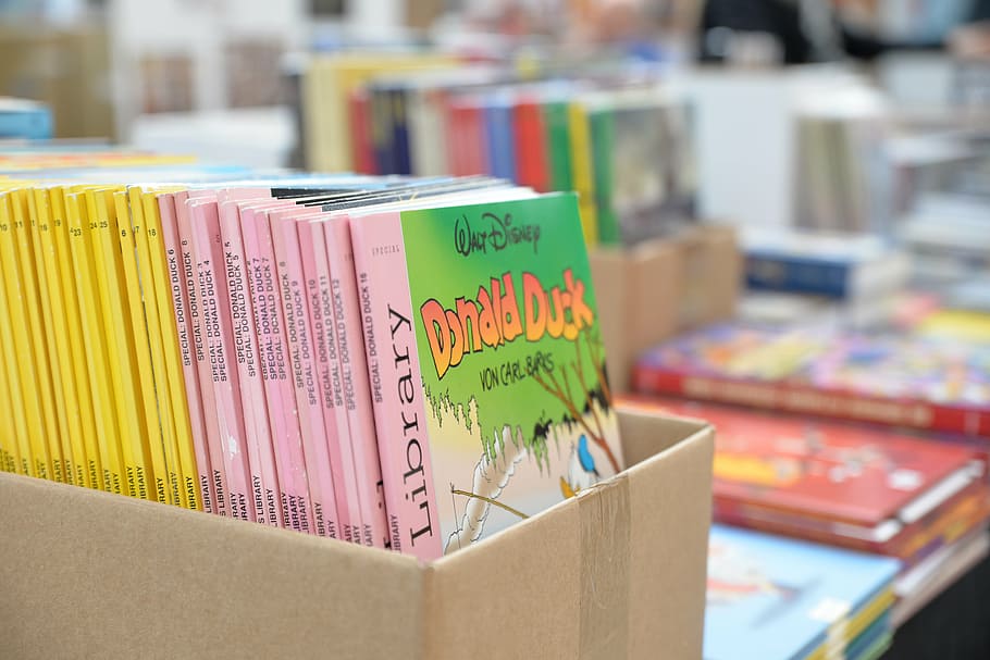 selective focus photography of Walt Disney books inside box HD wallpaper