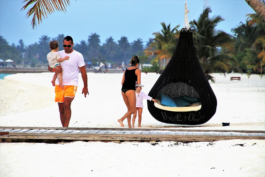 girl and woman standing near egg hanging chair, family, maldives