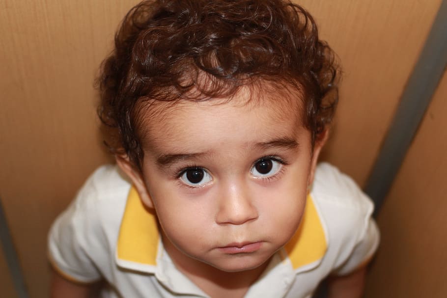 close-up photography of boy in white and yellow polo shirt, baby