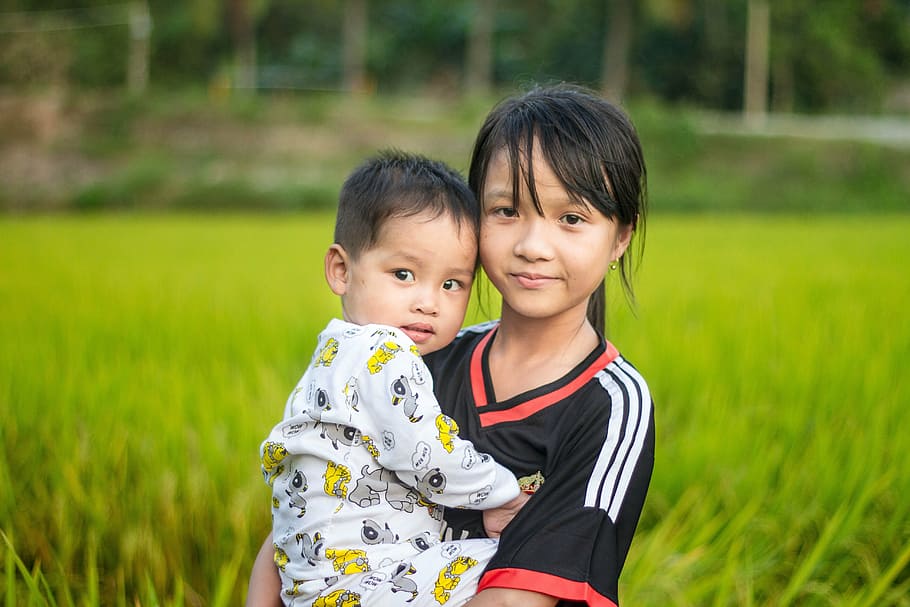 girl carrying baby on grass field, country, cute, eye, kids, nice