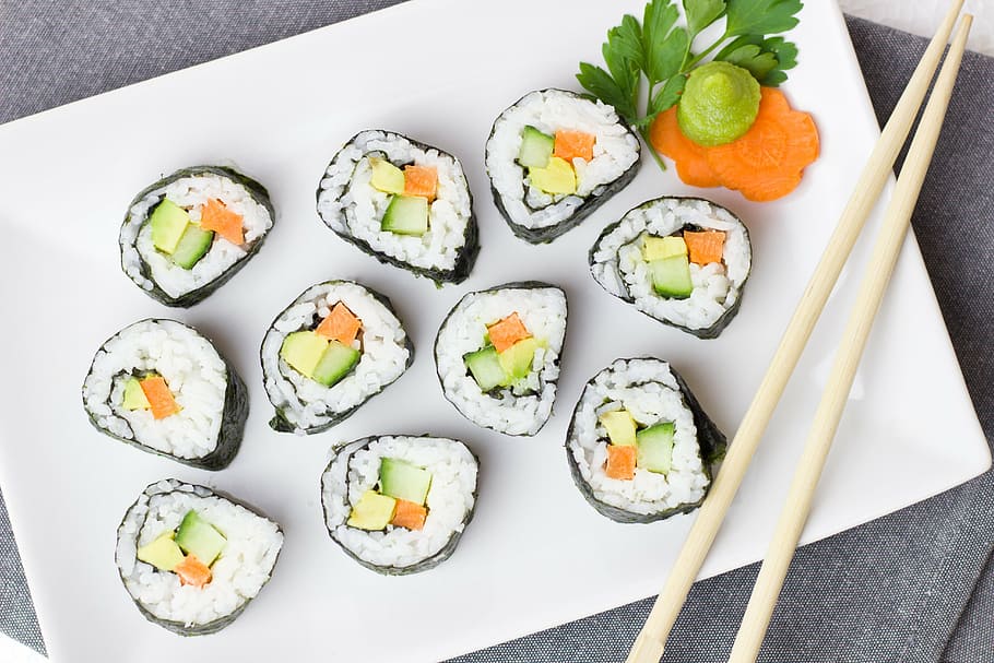 sushi rolls placed on white ceramic plate, vegetarian, vegetables
