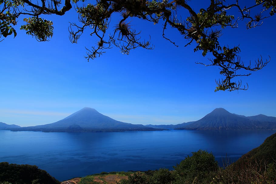 body of water in front of two mountains, guatemala, lake, central america
