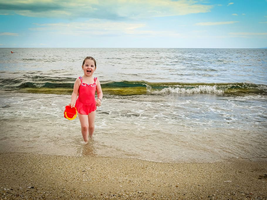 girl laughing while walking on seashore, Childhood, Happy, kid