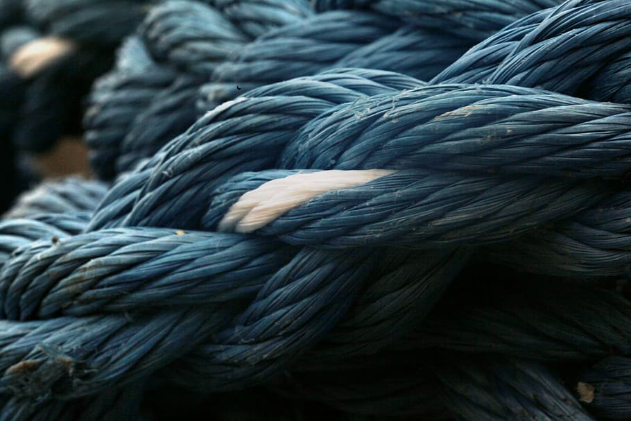 entangled blue and white ropes, closeup photo of blue tied rope