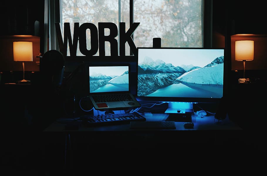 shallow focus photography of computer monitor, computer monitor and laptop on top of table near glass windowpane HD wallpaper