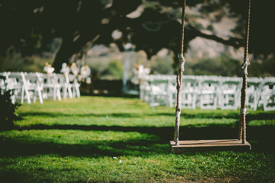 brown wooden base swing near white wooden chairs at daytime HD wallpaper