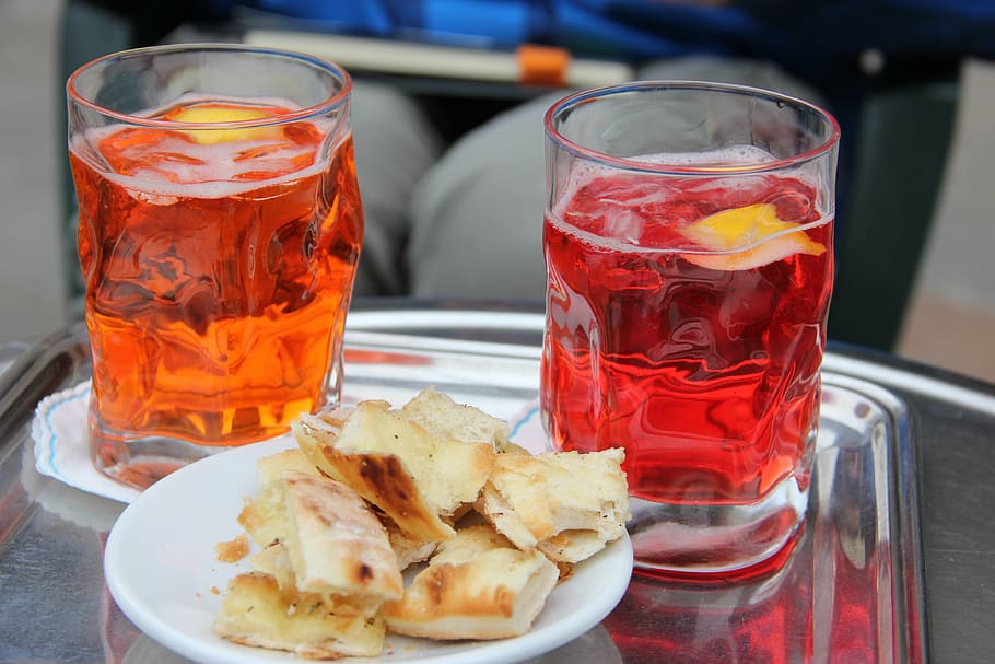 bread on plate and two cups filled with beverages, alcohol, glass