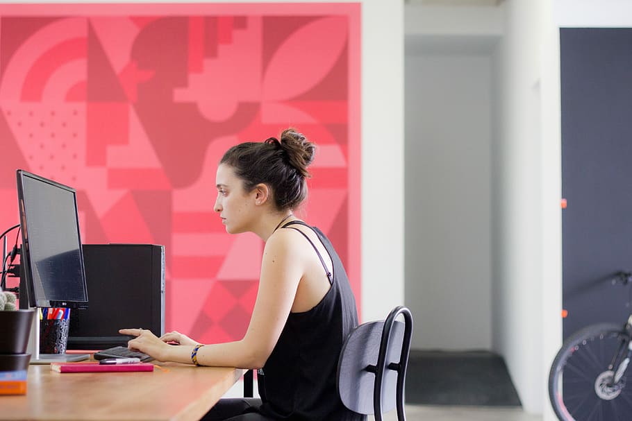 woman using computer inside the room, woman in black tank top facing black computer monitor HD wallpaper