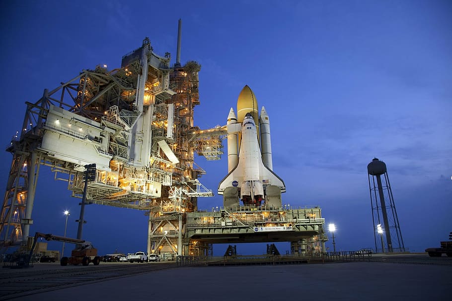 white spaceship during night time, atlantis space shuttle, rollout