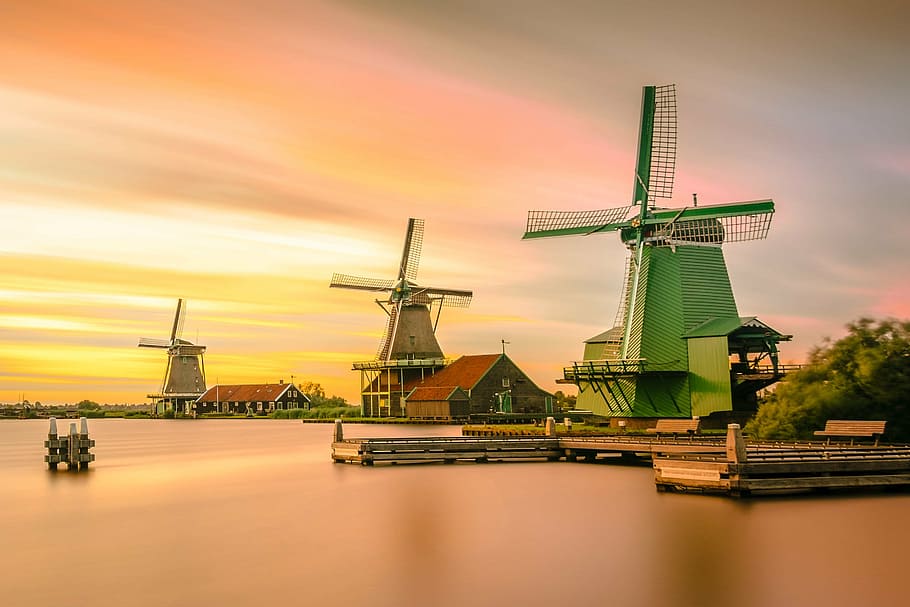 green windmill near body of water at sunset, architecture, bridge