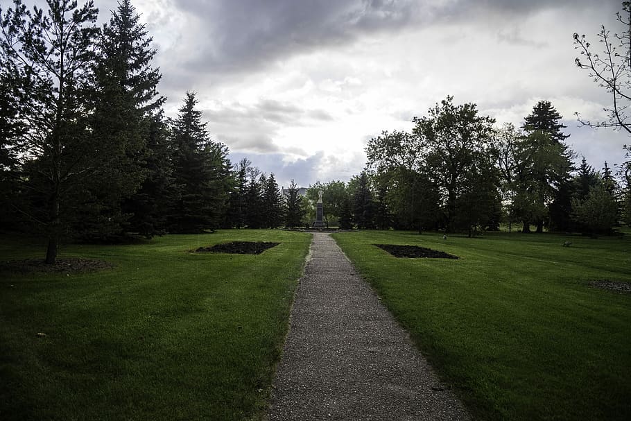 Path in the city park under dark skies in Saskatoon, clouds, grass HD wallpaper