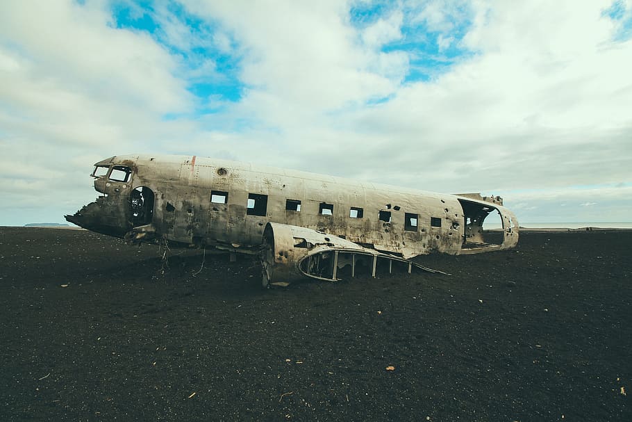 photo of abandoned plane under blue cloudy sky, gray ship on gray surface under white clouds HD wallpaper