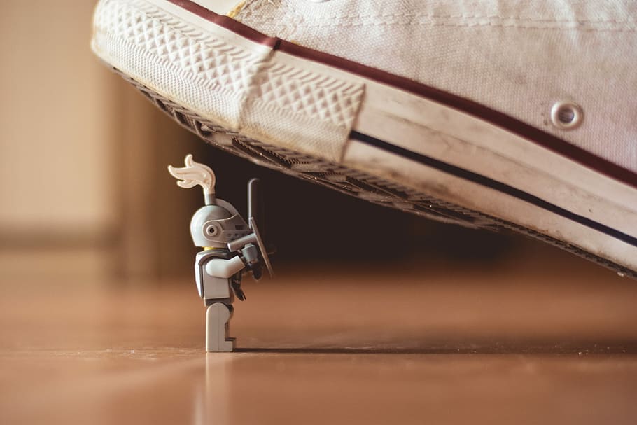 gray mini figure under white sneaker, LEGO knight warrior toy under white shoe, HD wallpaper