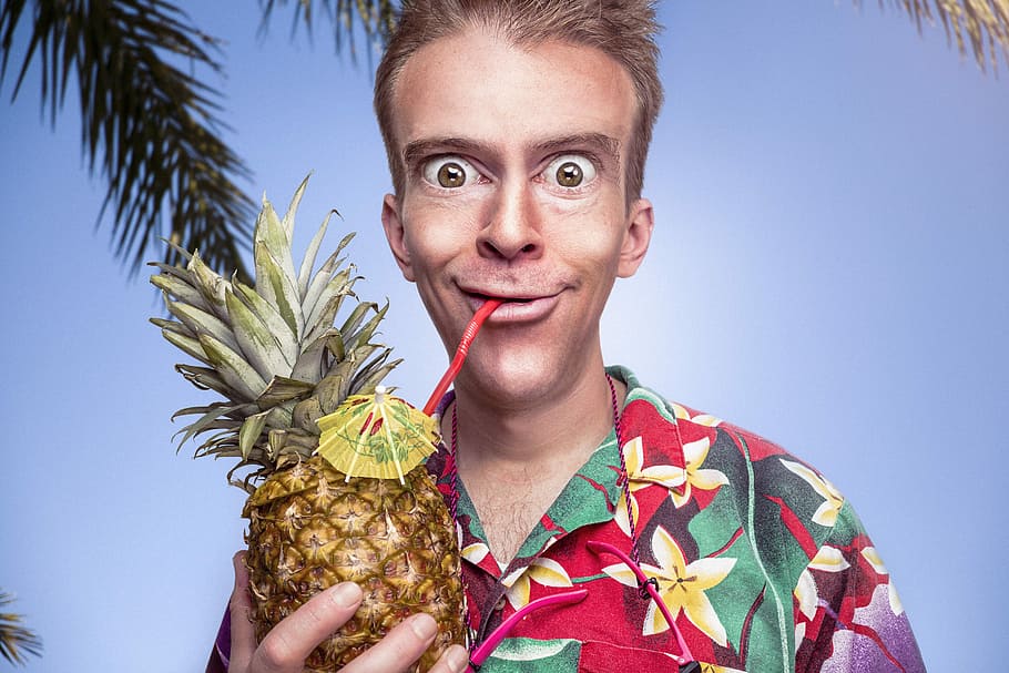 man in red, yellow, and green flora button-up shirt holding pineapple under blue sky, HD wallpaper