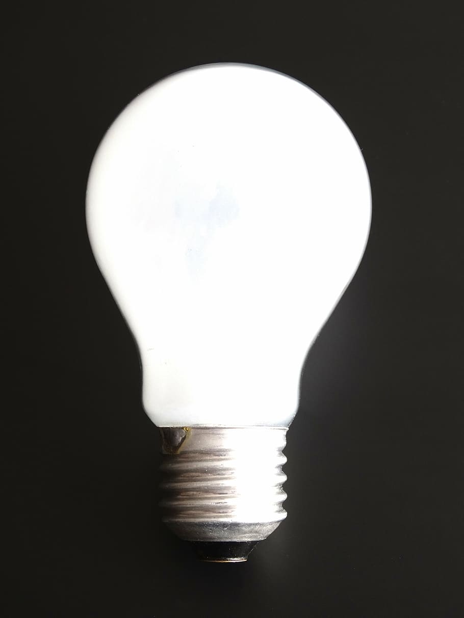 photography of white light bulb on black surface, light body