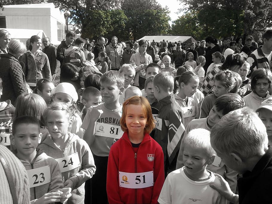 selective-color photography of child wearing red zip-up hooded jacket beside crowd of people during daytime, HD wallpaper