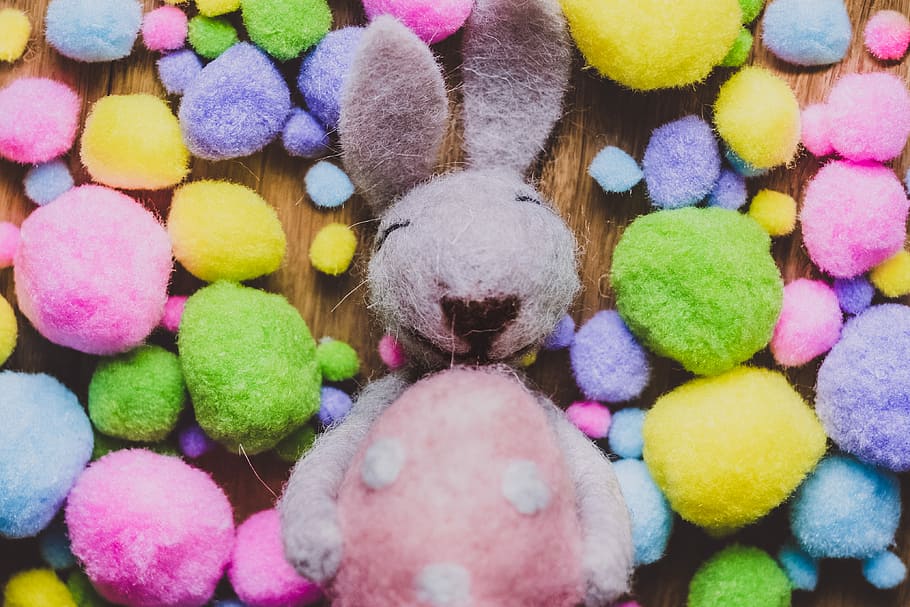 gray rabbit plus toy, gray and pink cotton bunny beside multicolored fabric balls HD wallpaper