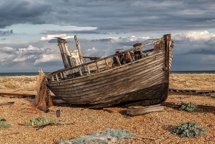 Wide-angle shot of an old abandoned fishing boat and nets. Image captured in Dungeness, Kent, England, HD wallpaper