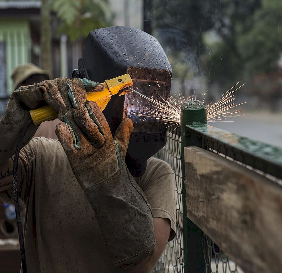 person wearing welding mask welding on green metal frame, construction, HD wallpaper