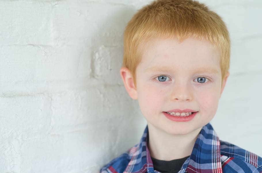 smiling boy near white painted wall, child, cool, happy, kid HD wallpaper