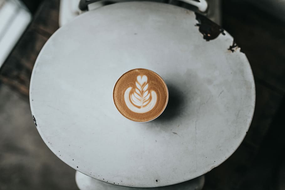 teacup with cappuccino on table, coffee in white ceramic cup on table HD wallpaper