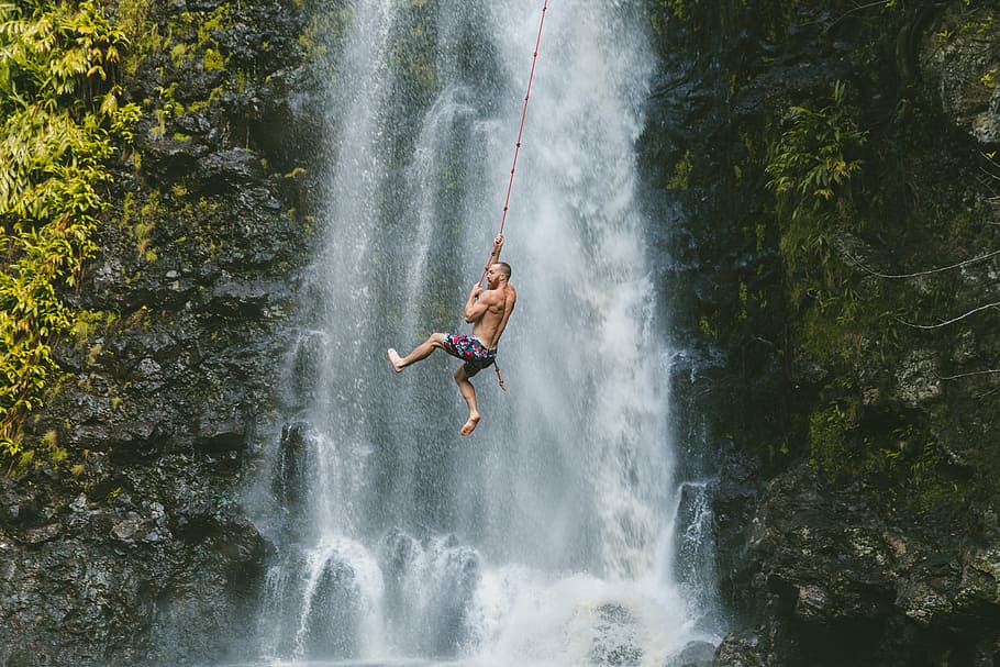man holding a rope against the waterfall, people, falls, nature HD wallpaper