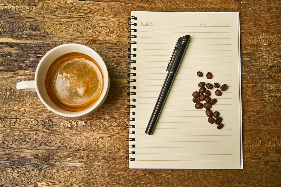 black ballpoint pen and coffee beans on white notebook, cup HD wallpaper