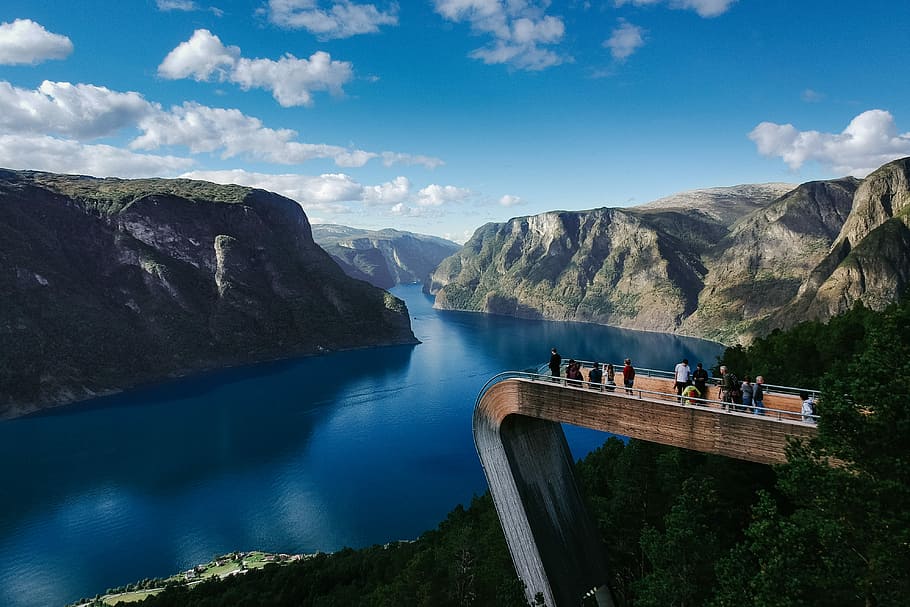 people standing on bridge looking through mountain surrounded by water, untitled HD wallpaper