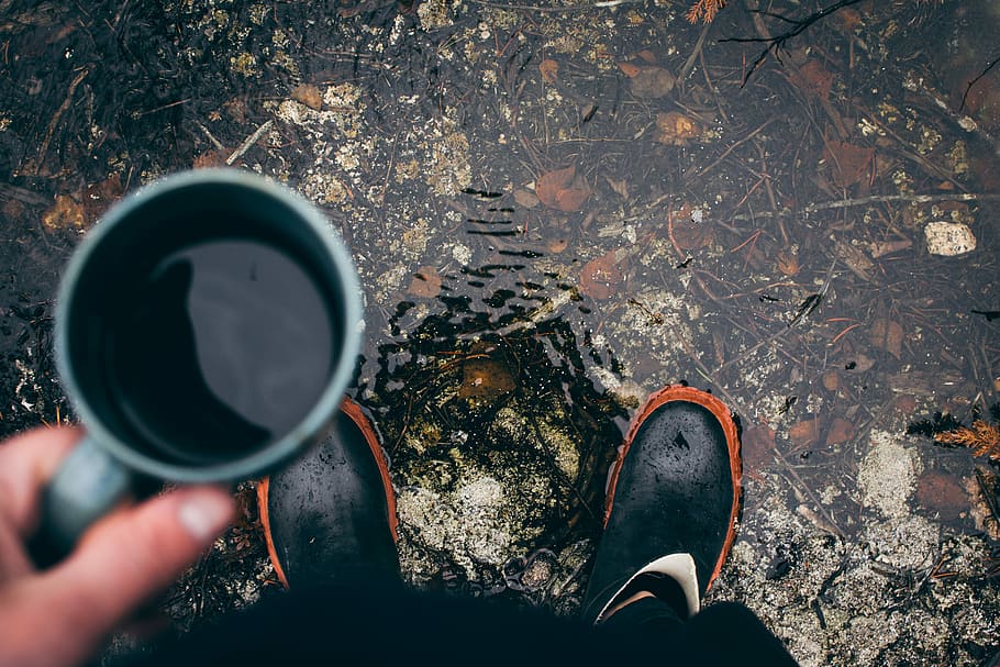 person holding coffee mug with pair of black shoes during daytime, person standing and holding gray ceramic mug with coffee, HD wallpaper