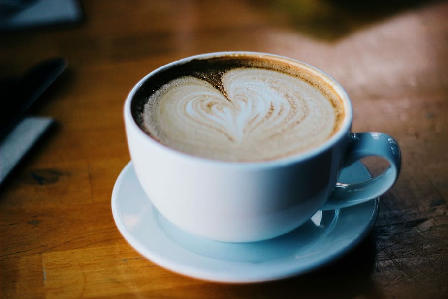 cup of cream coffee on brown surface, ceramic mug with heart-shape cappuccino HD wallpaper