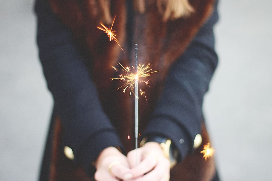person's hand holding firecracke, hands, light, macro, sparkler HD wallpaper