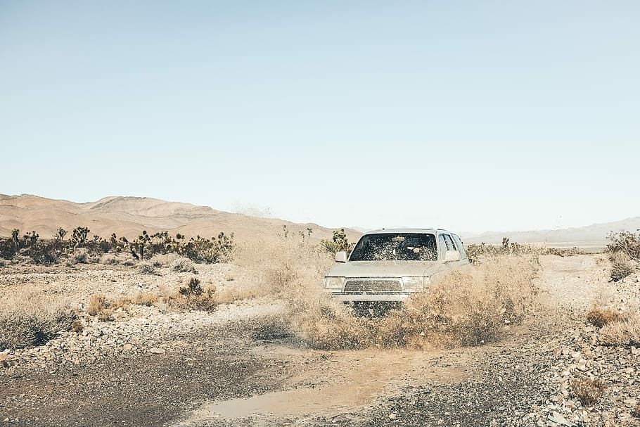 gray car at the rural road splashes a water under blue sky at daytime HD wallpaper