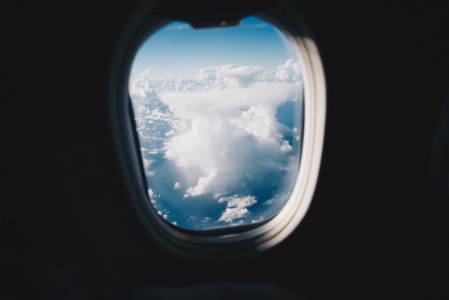 opened airplane window, aerial photo of airplane window, view