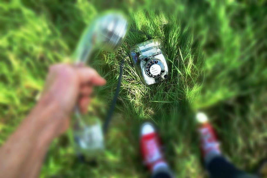 selective focus photography of cradle telephone on grass, vintage