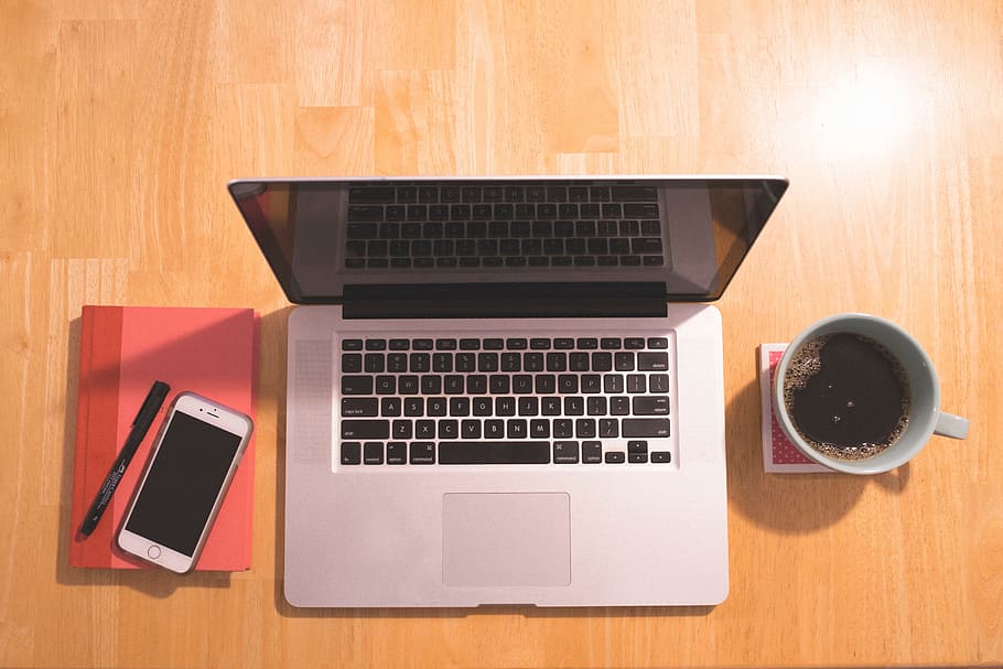 MacBook Pro beside white ceramic mug and silver iPhone 6, notebook HD wallpaper