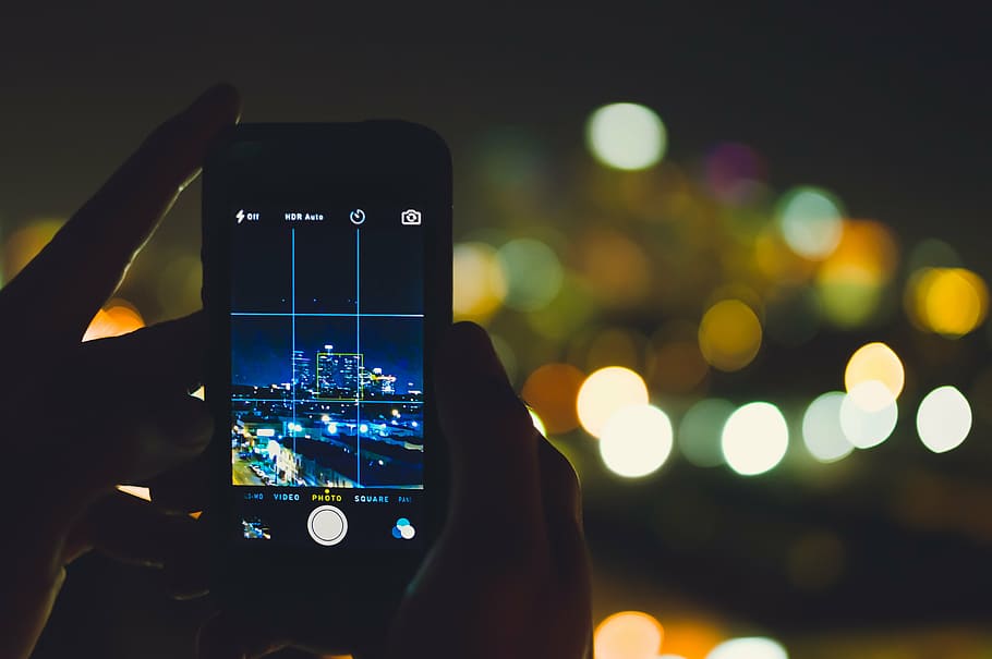 silver iPhone 6 showing building with background of bokeh lights HD wallpaper