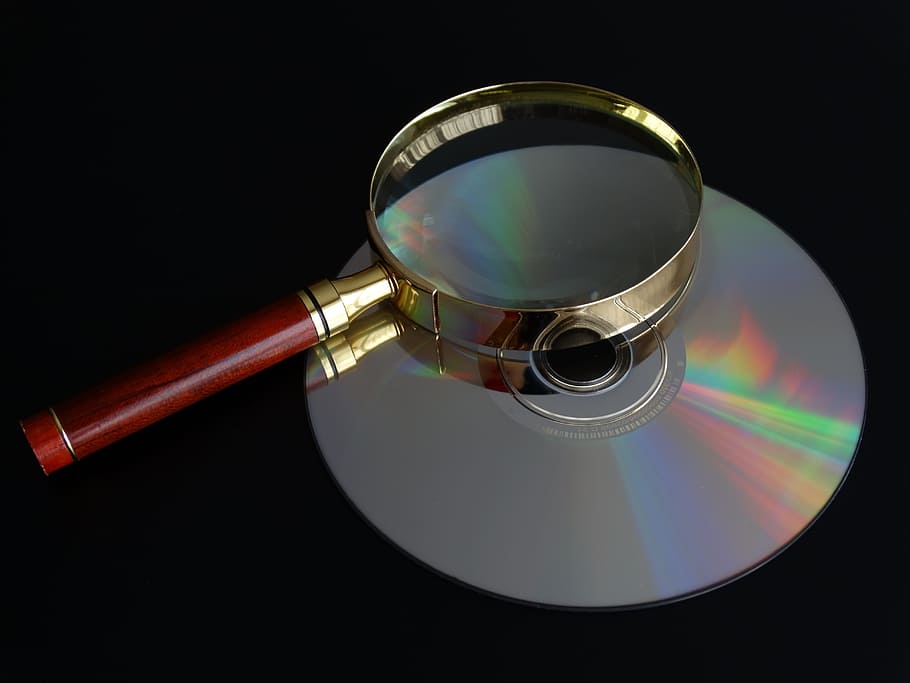 disc, magnifying glass, cd, close-up, indoors, no people, reflection