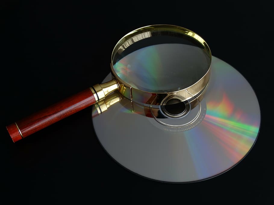 brown handle magnifying glass on top of disc, cd, data search HD wallpaper