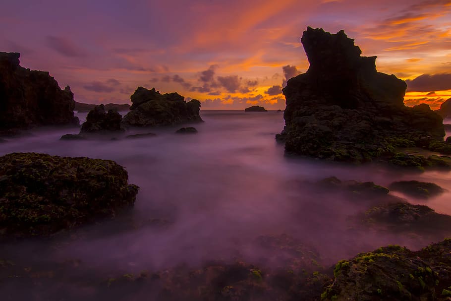 landscape photography of mountains covered with fogs, photograph of rock formations during golden hour HD wallpaper