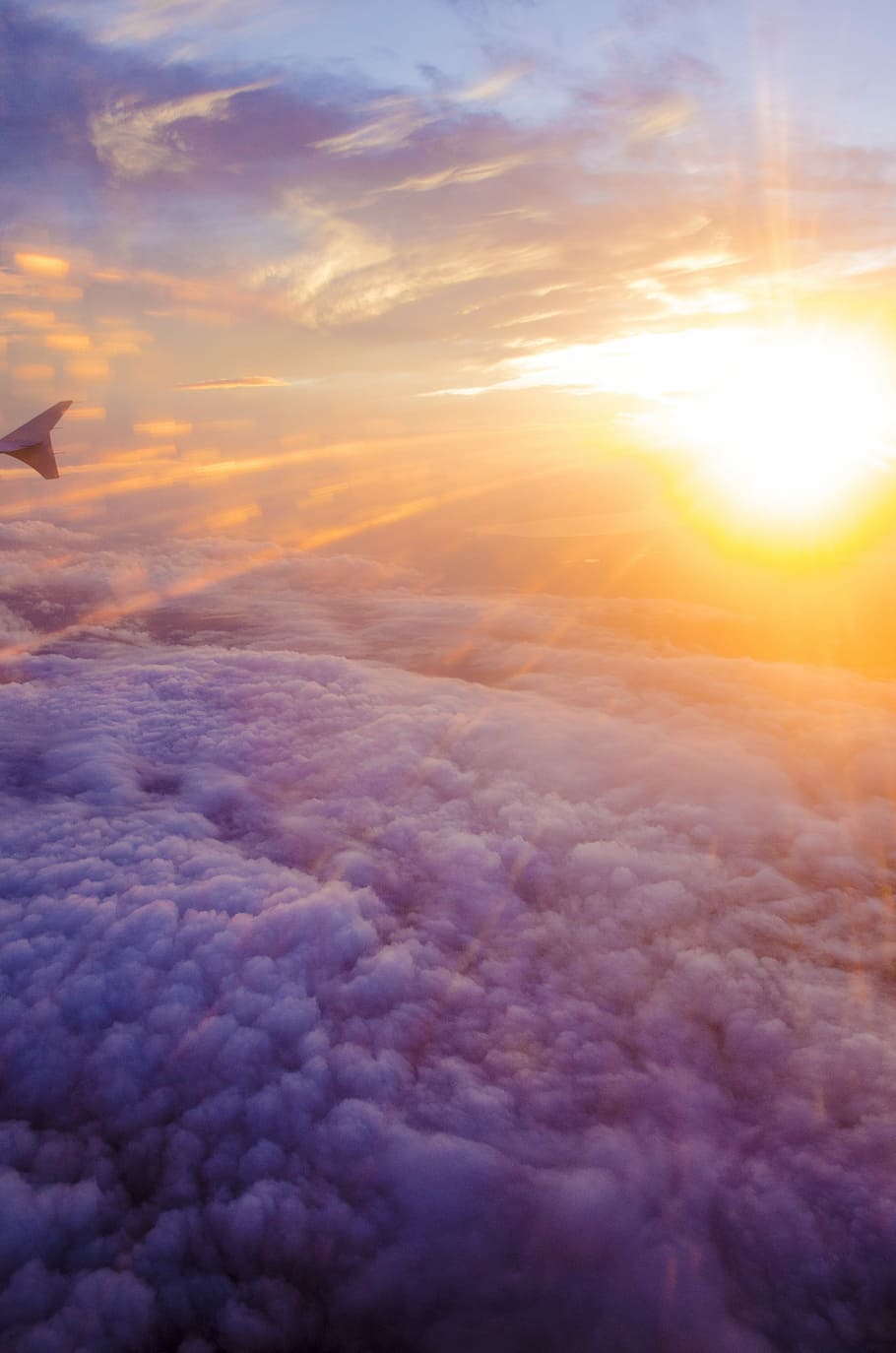 aerial photography of white clouds and sunlight, airliner above sea of clouds