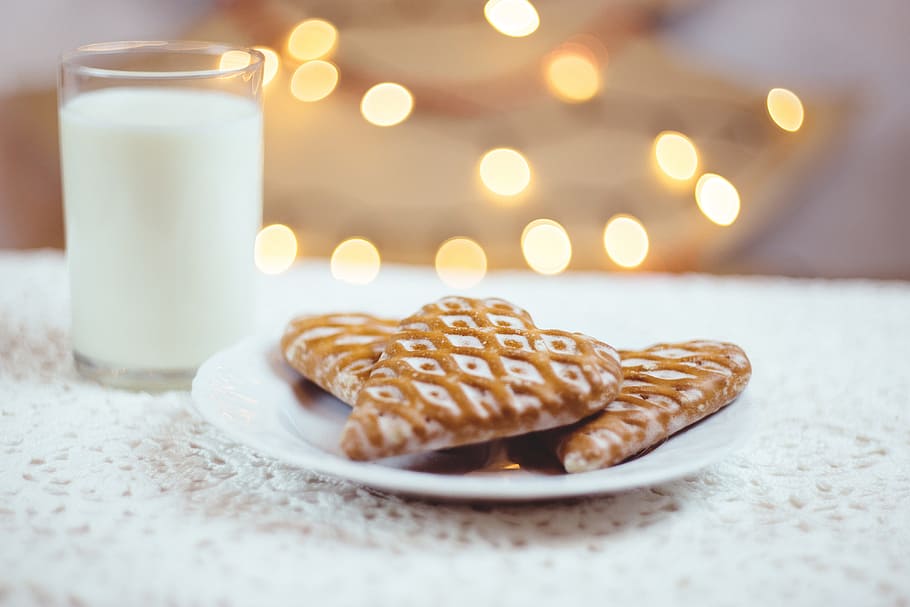 baked cookies on white ceramic saucer beside clear glass cup filled with white liquid HD wallpaper