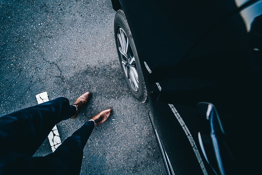 person standing near car, person wearing brown dress shoes near black car, HD wallpaper