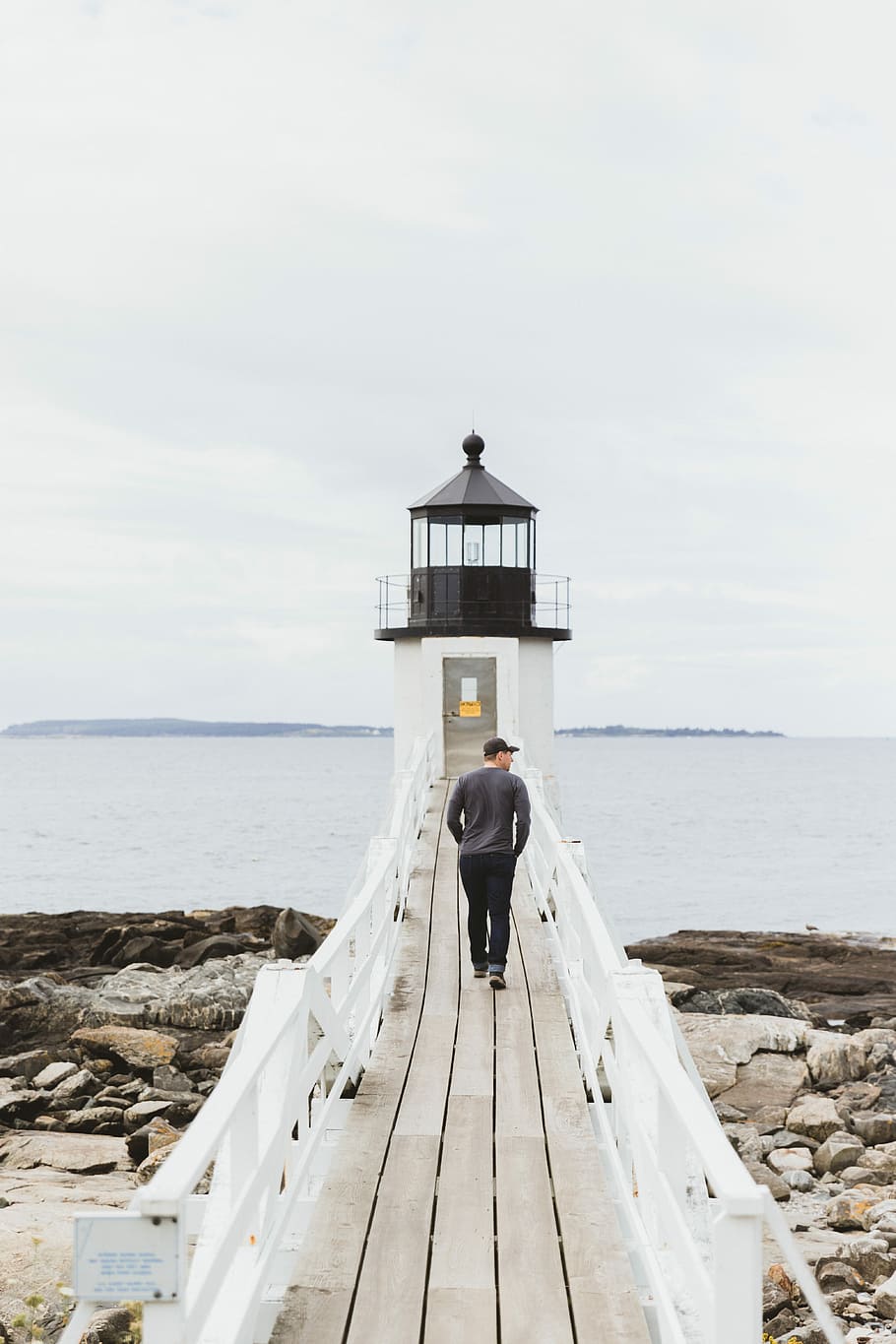 man in gray top walking on dock bridge, man walking on brown dock going to lighthouse HD wallpaper