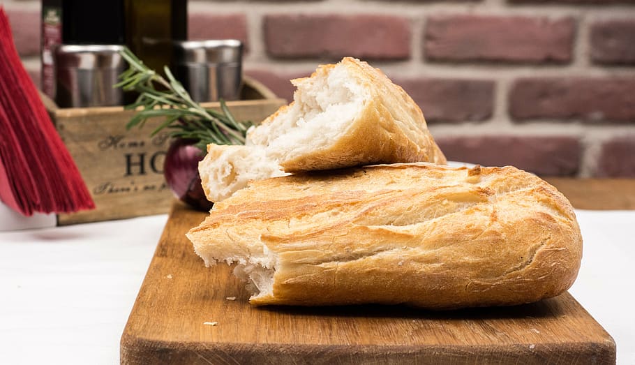 two slice breads on brown wooden chopping board, bakery, food, HD wallpaper