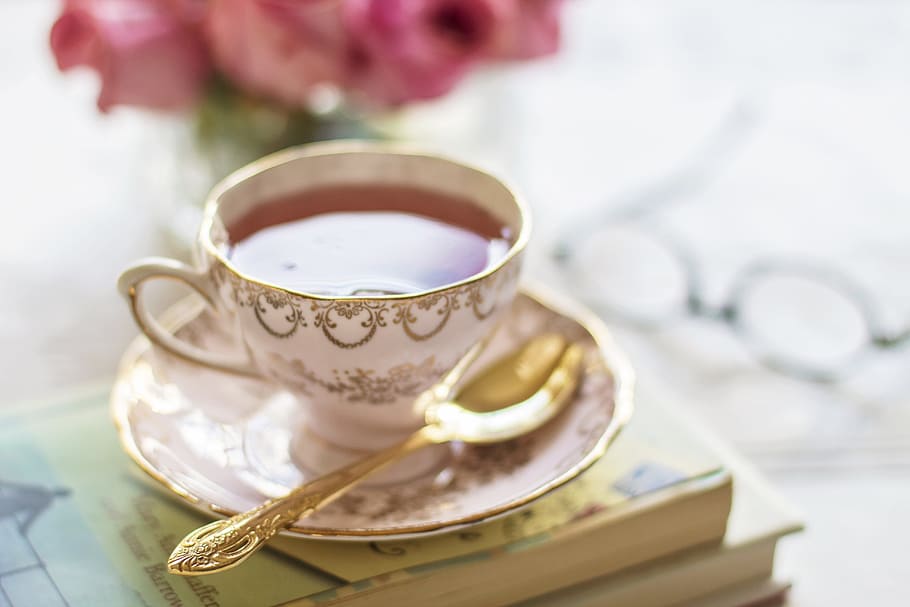 white and brown ceramic teacup with tea beside spoon on top of book, HD wallpaper