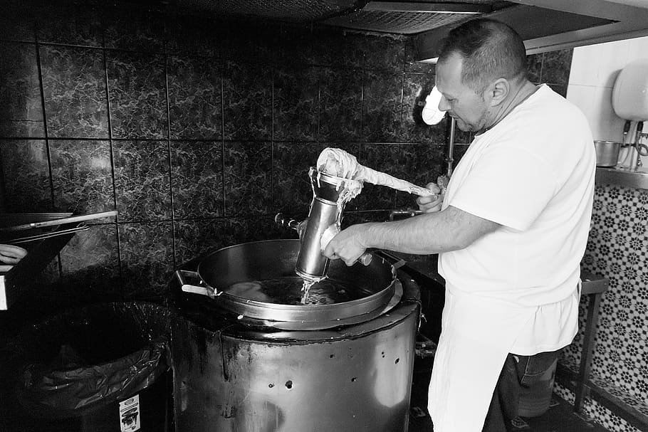 grayscale photography of man holding grey container inside the container, person using mixer machine HD wallpaper